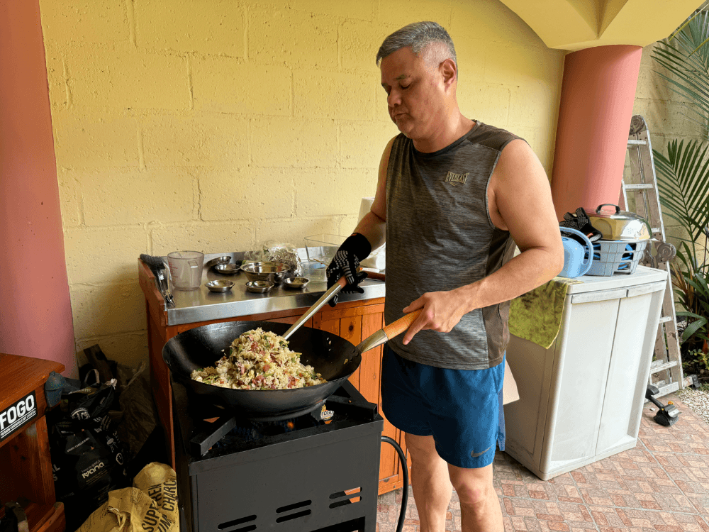 Jose cooking fried rice in his outdoor wok kitchen